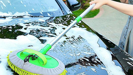 A girl washing a black car hood with carcarez two in one telescopic chenille car wash mop product blog image