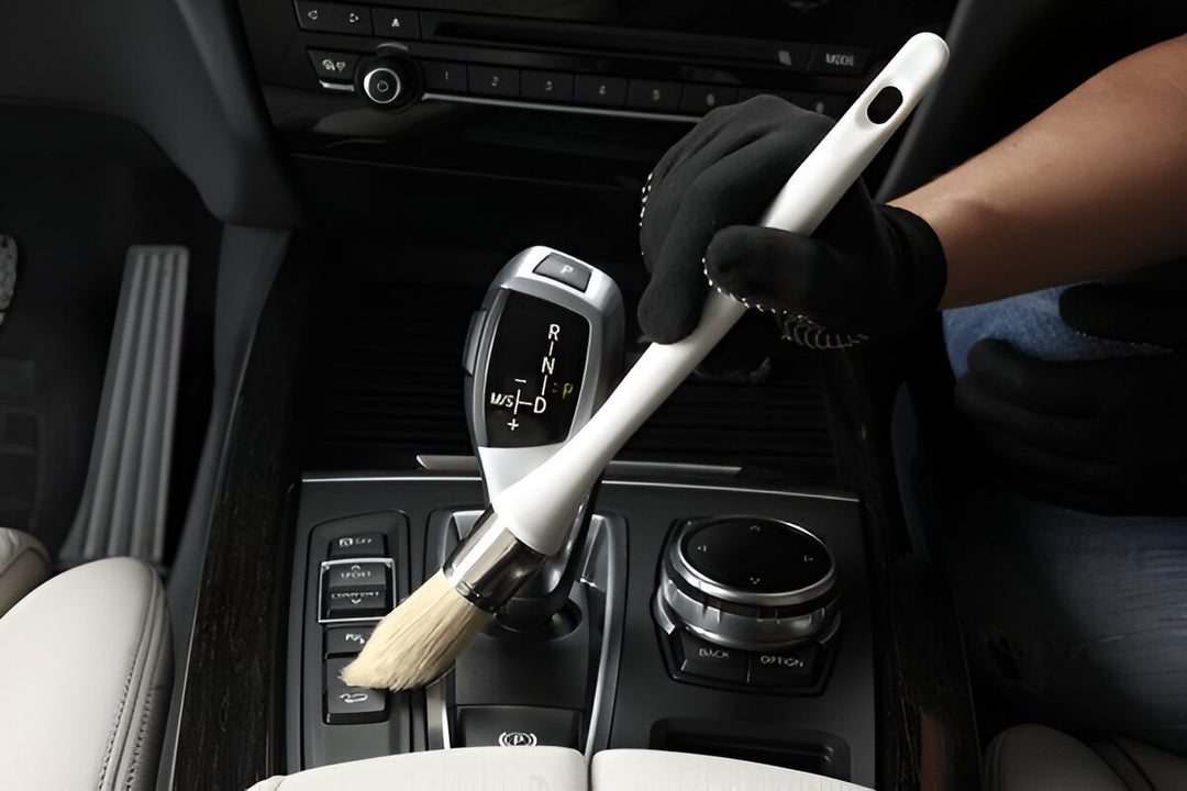 A Professional using CarCarez boar bristle detailing brush to clean car interior
