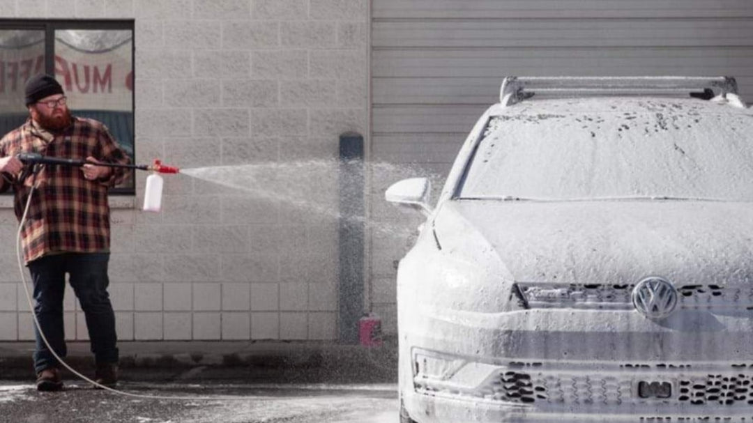 A man cleaning his car with a Carcarez Snow Foam pressure Gun, ensuring a thorough and efficient wash. Blog Image