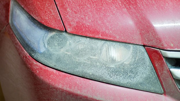 Close up view of Dirty red Car- CarCarez blog image