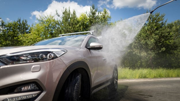 Person Cleaning Car with CarCarez Pressure Pump