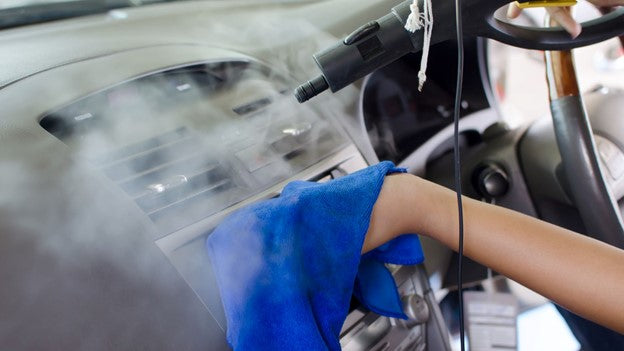 Person cleaning car interior with CarCarez Microfiber Towel
