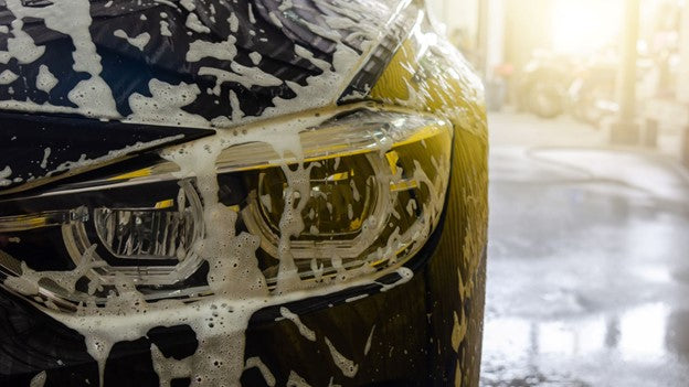 The person washing car with car carez foam canon