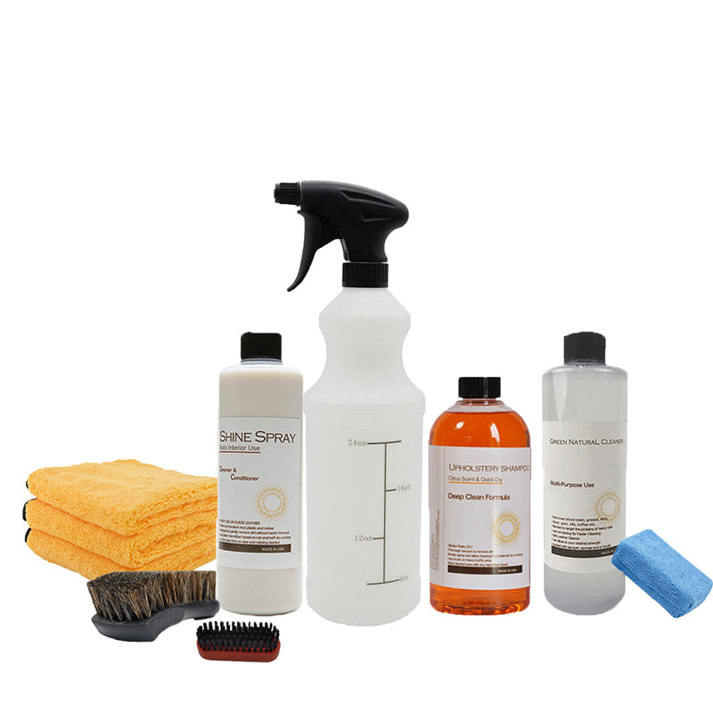 Collection of cleaning products including bottles, a brush, and cloths on a white background